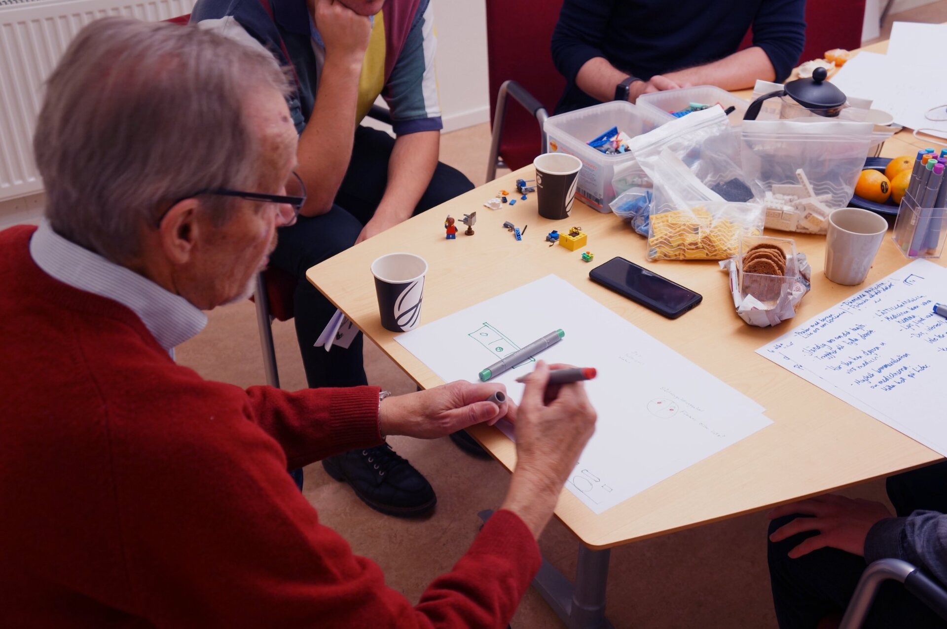 Co-design session – elderly patient drawing with markers and LEGO
