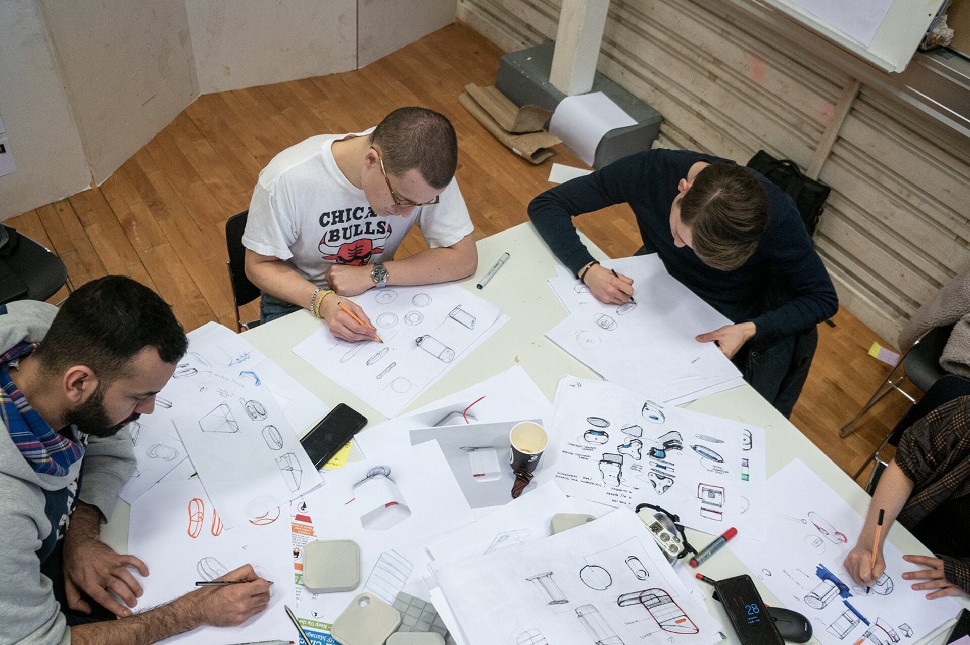 Team sketching industrial design concepts for portable dental kit